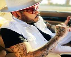 He is a tattoo freak and has several tattoos on both of his arms, neck as well as on his face.